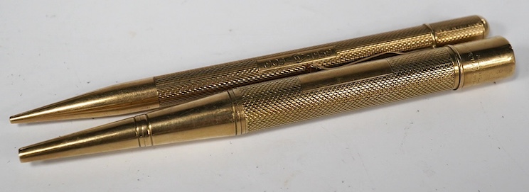 Two engine turned 9ct gold pencils, hallmarked for London, 1959 and London, 1969, both approx. 11.8cm. Condition - fair to good